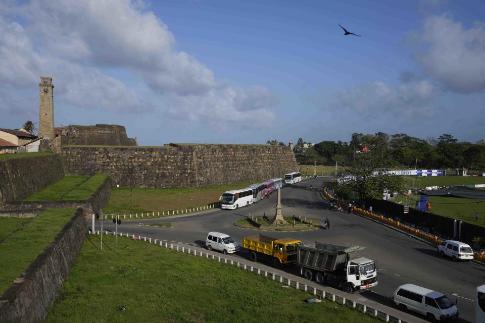 People wait hoping to receive cooking gas and fuel outside the 17th century built Dutch fortress, opposite Galle International Cricket Stadium ahead of the first test cricket matches between Australia and Sri Lanka in Galle, Sri Lanka, Tuesday, June 28, 2022. (AP Photo/Eranga Jayawardena)