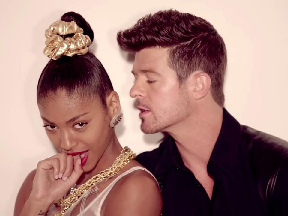 Robin Thicke singing into a girl's ear