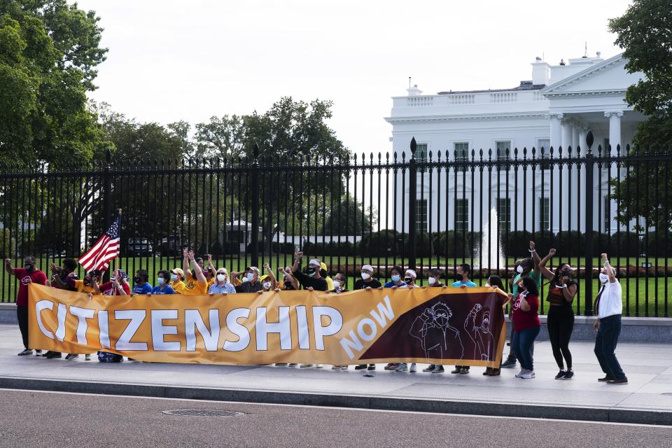 Protesters risk arrest as they rally on the sidewalk by the White House on Pennsylvania Avenue, Thursday, Oct. 7, 2021, in Washington. The protesters urged Vice President Kamala Harris and Senate Democrats to include immigration reform in the reconciliation package. (AP Photo/Jacquelyn Martin)