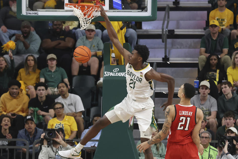 Baylor center Yves Missi (21) dunks the ball past Texas Tech guard KyeRon Lindsay (21) during the second half of an NCAA college basketball game Tuesday, Feb.6, 2024, in Waco, Texas. (AP Photo/Jerry Larson)