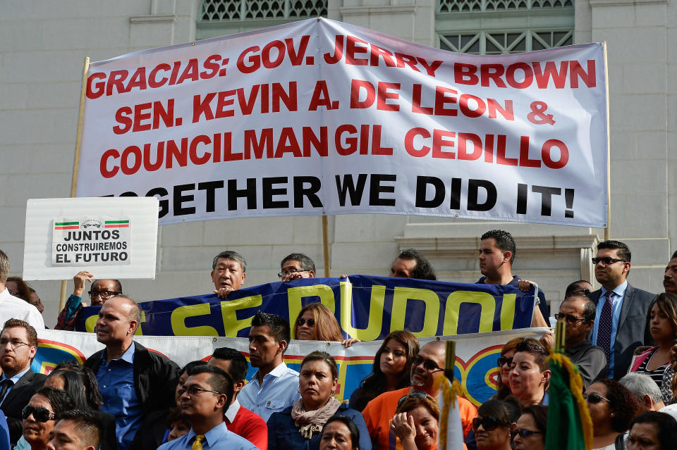 LOS ANGELES, CA - OCTOBER 03:  People celebrate after California Governor Jerry Brown signed bill AB60 on the steps of Los Angeles City Hall  October 3, 2013 in Los Angeles, California. California Assembly Bill 60 also known as the Safe and Responsible Driver Act allows illegal immigrants to receive a permit to legally drive in California.  (Photo by Kevork Djansezian/Getty Images)