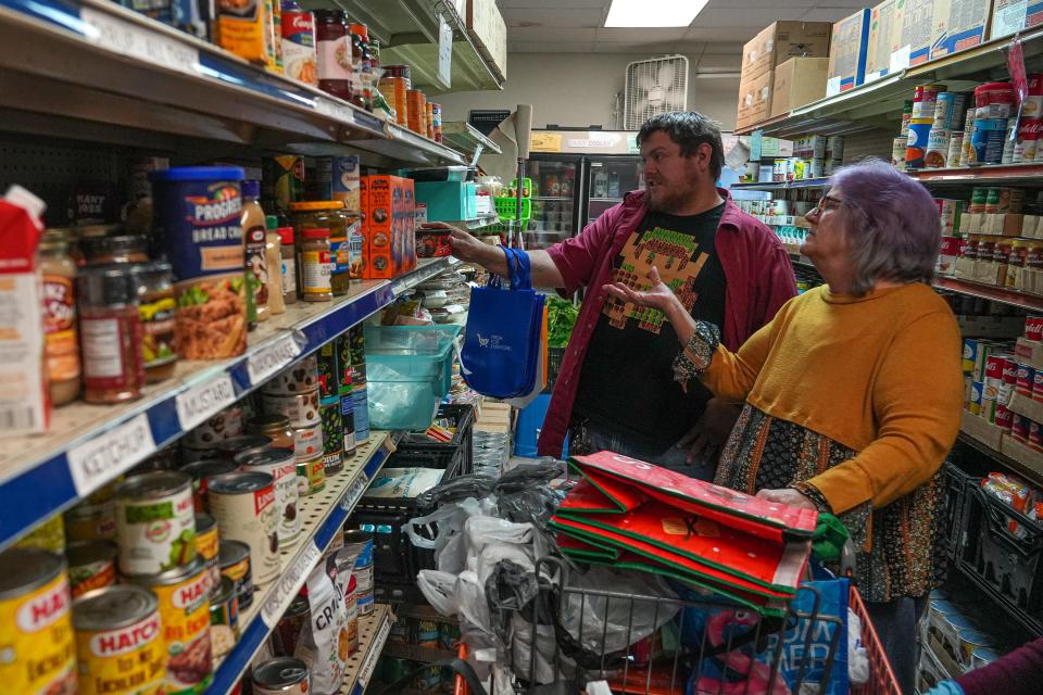Hutto resident Cathy Dahms and her son Michael shop for food at the Round Rock Area Serving Center in December. Cathy Dahms said the center's pantry eases the financial burden on her family.