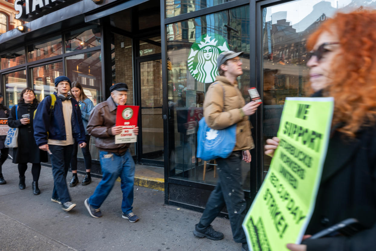 NEW YORK CITY - NOVEMBER 16: People picket outside of a Starbucks store in New York's East Village as Starbucks Workers United have announced that they are waging the company's largest strike Thursday on the coffee company's Red Cup Day on November 16, 2023 in New York City. Across the country, thousands of Starbucks workers from around 200 unionized stores will go on strike on the annual Red Cup Day, which gives customers a free reusable cup after ordering a holiday drink. The union has said it is demanding that the company bargain on issues including staffing and scheduling. (Photo by Spencer Platt/Getty Images)