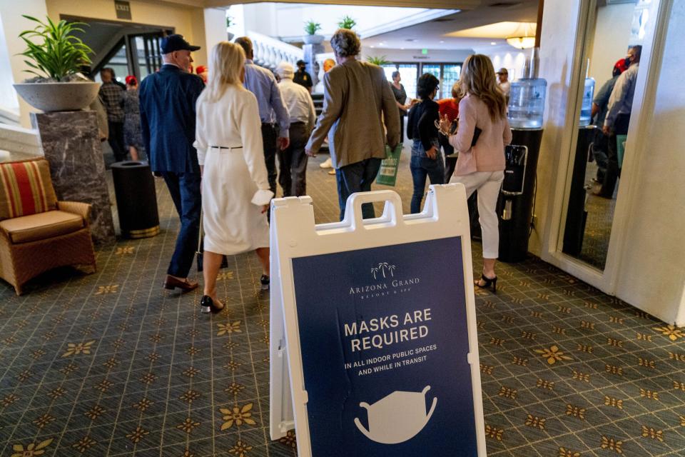 A sign reads "Masks Are Required" outside a Latinos for Trump Coalition roundtable where President Donald Trump spoke at Arizona Grand Resort & Spa, Monday, Sept. 14, 2020, in Phoenix. (AP Photo/Andrew Harnik)