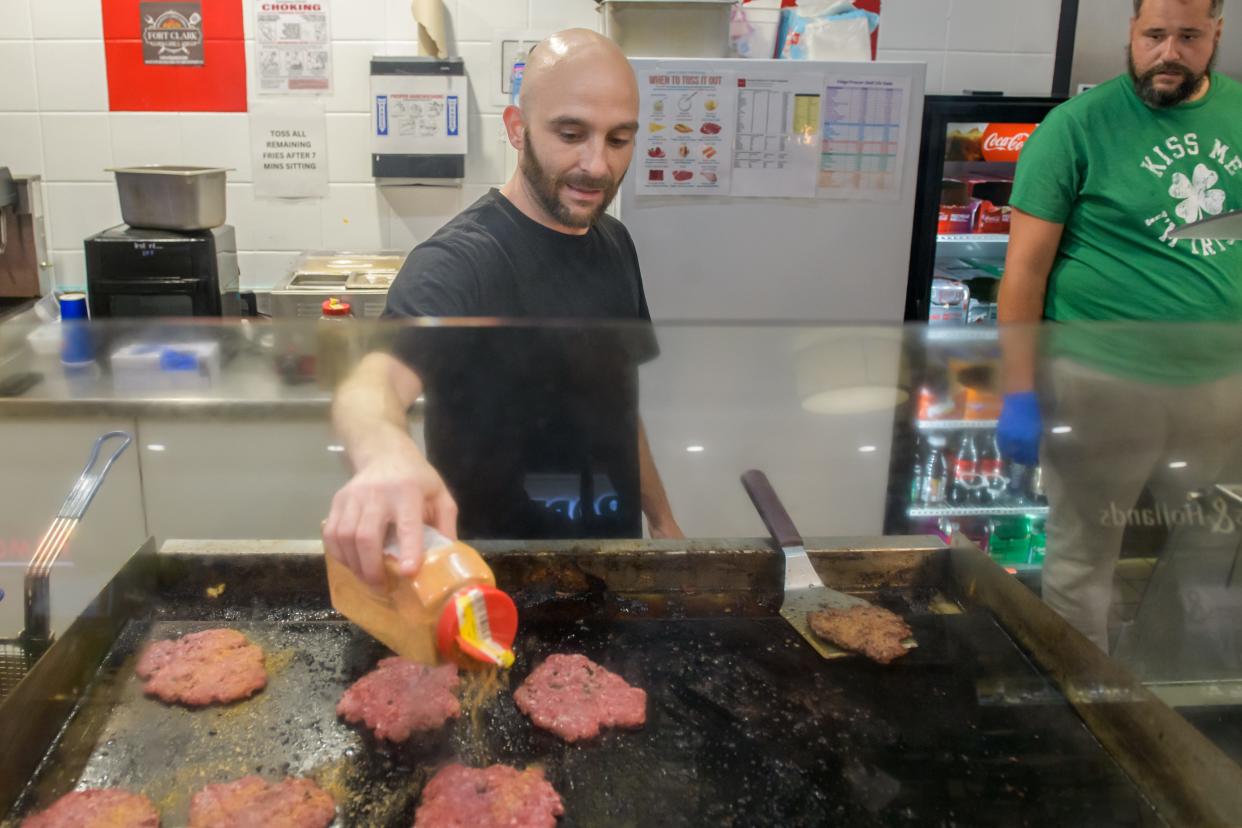 Shawn Holler works the grill at his restaurant Fort Clark Grill at the Northwoods Mall in Peoria.