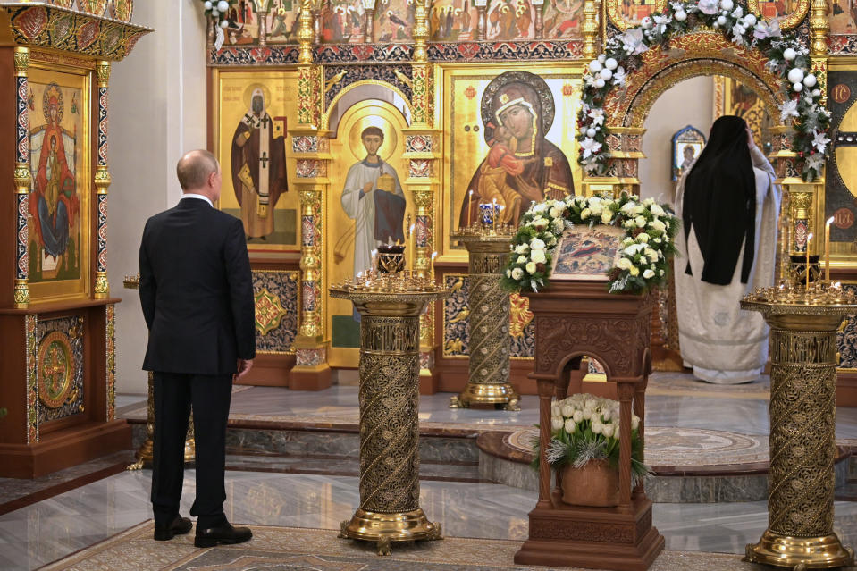 Russian President Vladimir Putin attends the Orthodox Christmas Litturgy in the Church of the Image of the Saviour Made Without Hands in Novo-Ogaryovo, outside Moscow, Russia, late Thursday, Jan. 6, 2022. Orthodox Christians celebrate Christmas on Jan. 7, in accordance with the Julian calendar. (Alexei Nikolsky/ Sputnik, Kremlin Pool Photo via AP)