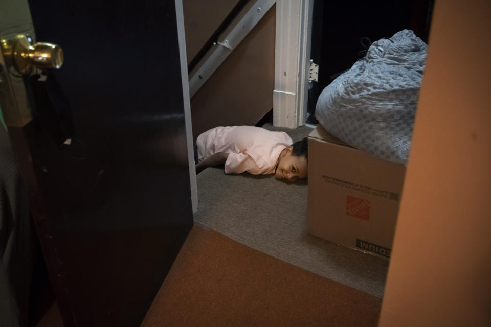 Carter Manson lays on the top of a stairwell, pretending to be exhausted in Hartford, Conn., on Wednesday, May 25, 2022. While Connecticut has been touted as one of the nation's healthiest states, it suffers from the nation's highest rate of childhood asthma, 11%, with children of color – especially Black children like Carter and his sister – hit the hardest. (AP Photo/Wong Maye-E)