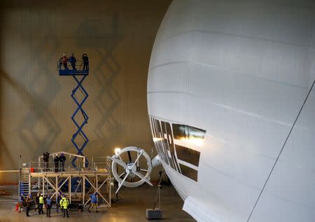 Members of the media film the Airlander 10 hybrid airship during its unveiling in Cardington, Britain March 21, 2016. REUTERS/Darren Staples