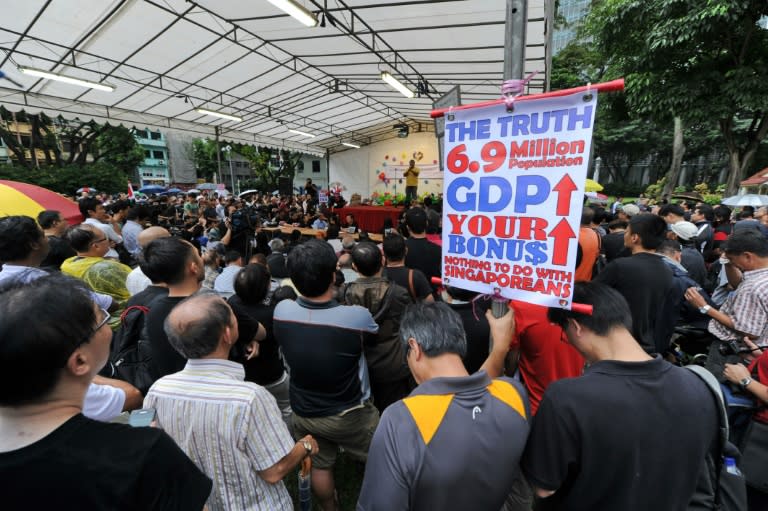 People gather to listen to people talk about immigration issues, in Singapore on February 16, 2013