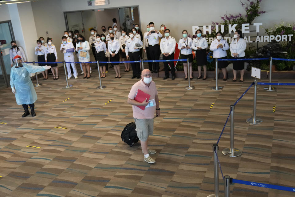 One of the first tourists arrive from Abu Dhabi at the Phuket International Airport in Phuket, Thailand, Thursday, July 1, 2021. Starting Thursday, Thailand will welcome back international visitors — as long as they are vaccinated — to its famous southern resort island of Phuket without having to be cooped up in a hotel room for a 14-day quarantine. (AP Photo/Sakchai Lalit)