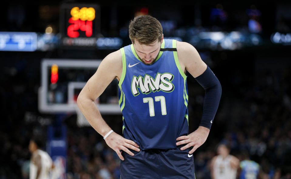 Luka Doncic ripped his own jersey down the middle after missing free throws in loss to Lakers on Friday night. (AP/Brandon Wade)