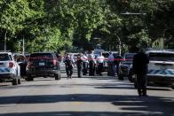 Police investigate the scene of a shooting outside a home in Chicago, Tuesday, June 15, 2021. Police say an argument at a house on Chicago's South Side erupted in fatal gunfire, leaving some dead and others injured.