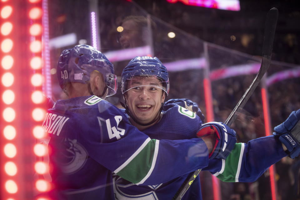 Vancouver Canucks' Andrei Kuzmenko, right, celebrates his third goal against the Anaheim Ducks, during the third period of an NHL hockey game Thursday, Nov. 3, 2022, in Vancouver, British Columbia. (Ben Nelms/The Canadian Press via AP)