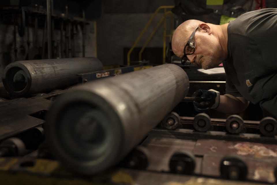 A steel worker inspects a 155 mm M795 artillery projectile during the manufacturing process at the Scranton Army Ammunition Plant in Scranton, Pa., Thursday, April 13, 2023. One of the most important munitions of the Ukraine war comes from a historic factory in this city built by coal barons, where tons of steel rods are brought in by train to be forged into the artillery shells Kyiv can’t get enough of — and that the U.S. can’t produce fast enough. (AP Photo/Matt Rourke)