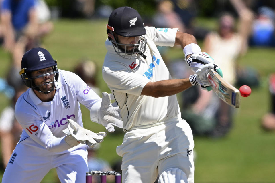 New Zealand's Daryl Mitchell, right, bats in front of England's Ben Foakes on the fourth day of their cricket test match in Tauranga, New Zealand, Sunday, Feb. 19, 2023. (Andrew Cornaga/Photosport via AP)