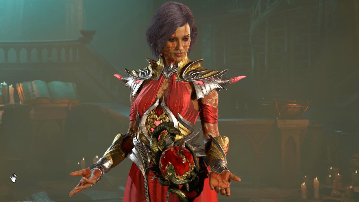  Diablo 4 Sorceress wearing red metallic armor looking down at her hands. 