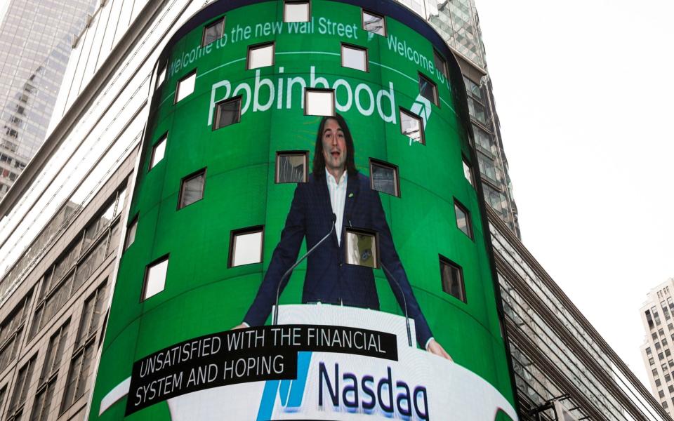 Vlad Tenev, CEO and co-founder Robinhood, is displayed on a screen during his company's IPO at the Nasdaq Market site in Times Square, New York  - BRENDAN MCDERMID /Reuters