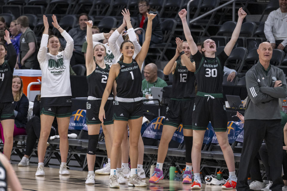 Green Bay players celebrate on the bench during the second half against Cleveland State in the championship game of the women's NCAA college basketball Horizon League Conference Tuesday, March 12, 2024, in Indianapolis. (AP Photo/Doug McSchooler)