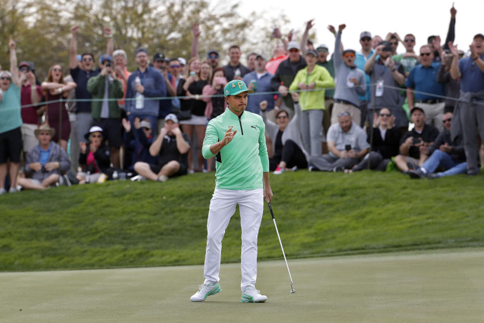 Rickie Fowler waves after making a birdie putt on the fifth green during the third round of the Phoenix Open PGA golf tournament, Saturday, Feb. 2, 2019, in Scottsdale, Ariz. (AP Photo/Matt York)