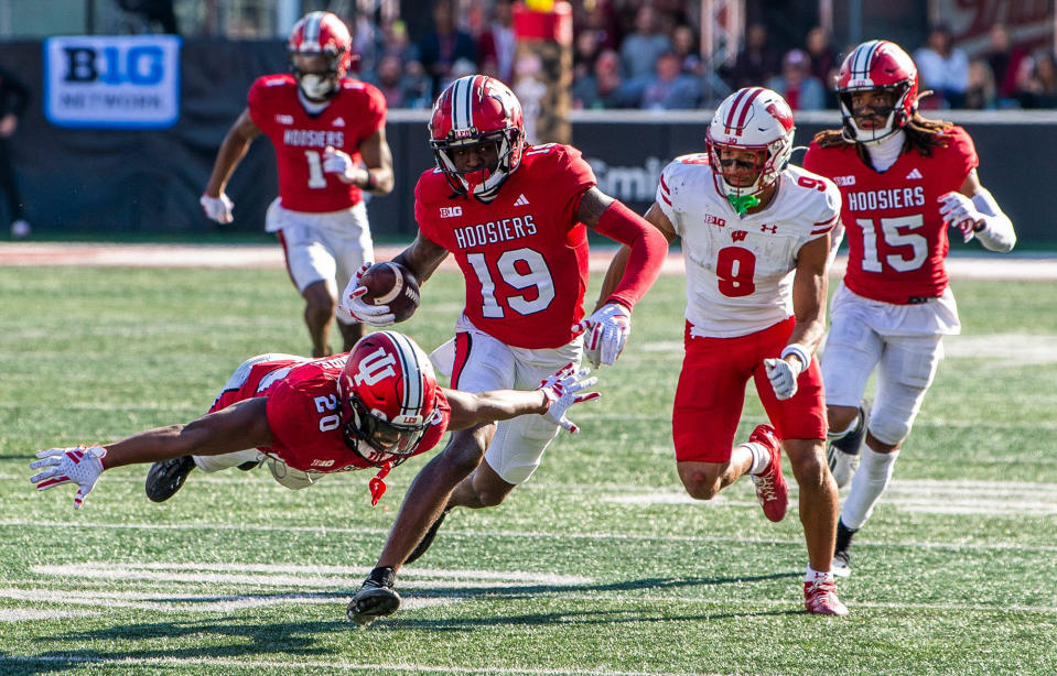 Nov 4, 2023; Bloomington, Indiana, USA; Indiana’s Louis Moore (20) starts to celebrate as Josh Sanguinetti runs back a fumble during the second half of a victory over the Wisconsin Badgers during the second half at Memorial Stadium. Mandatory Credit: Rich Janzaruk-USA TODAY Sports