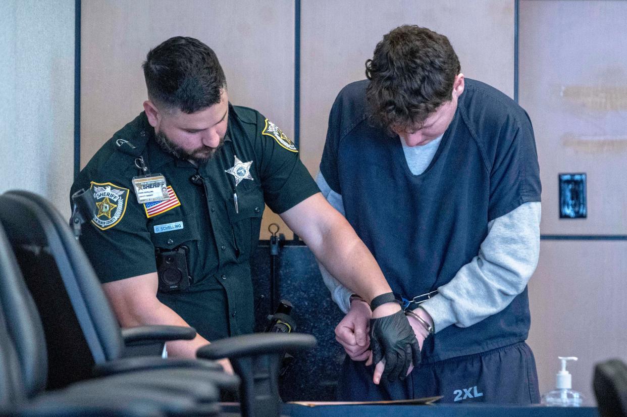 Tzvi Allswang, right, is finger-printed at the Palm Beach County Courthouse on March 12, 2024 in West Palm Beach after he pleaded guilty to multiple counts of sexual assault as well as attempted murder of his therapist.