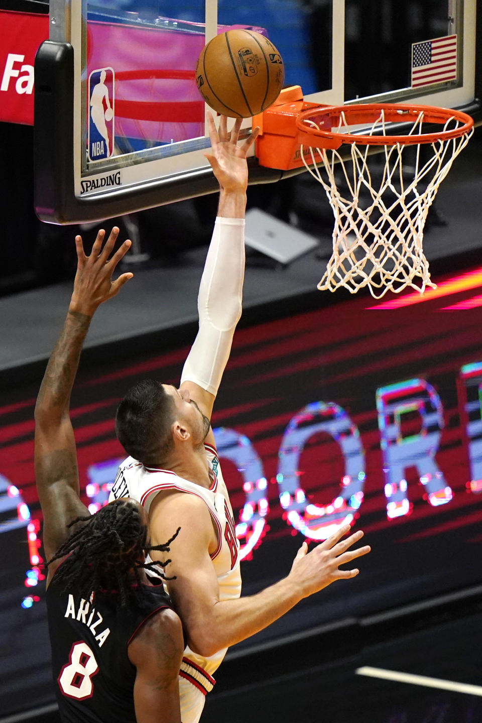 Chicago Bulls center Nikola Vucevic, right, shoots over Miami Heat forward Trevor Ariza (8) during the first half of an NBA basketball game, Monday, April 26, 2021, in Miami. (AP Photo/Lynne Sladky)