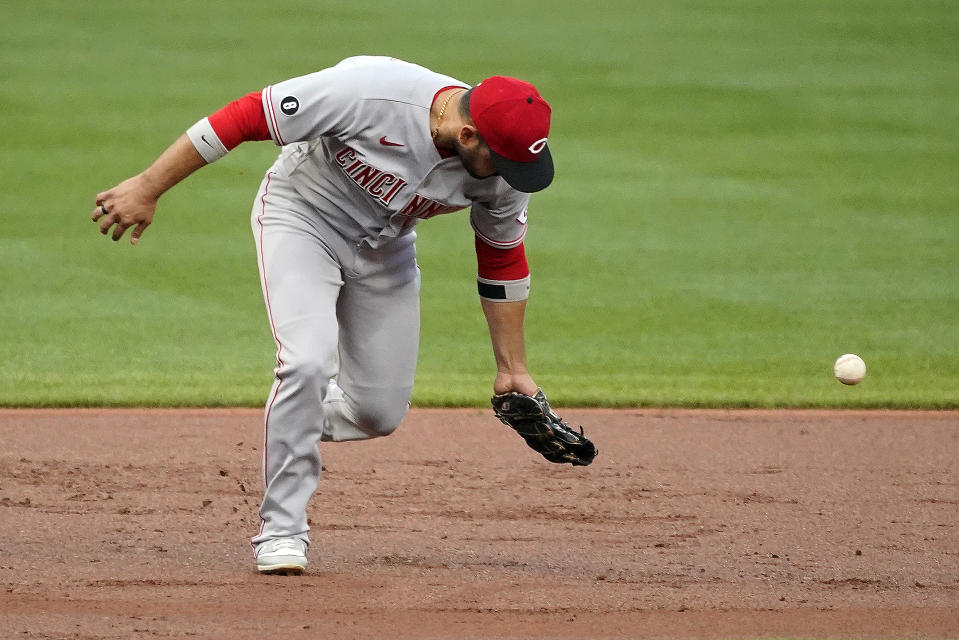 Cincinnati Reds third baseman Eugenio Suarez misplays a ball allowing Pittsburgh Pirates' Anthony Alford to reach base during the first inning of a baseball game in Pittsburgh, Tuesday, Sept. 14, 2021. (AP Photo/Gene J. Puskar)