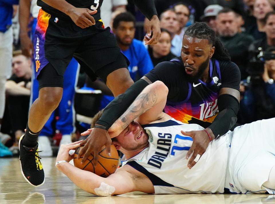 May 10, 2022; Phoenix, Arizona; USA; Suns forward Jae Crowder (99) tries to pry the ball loose from Mavericks guard Luka Doncic (77) during game 5 of the second round of the Western Conference Playoffs.