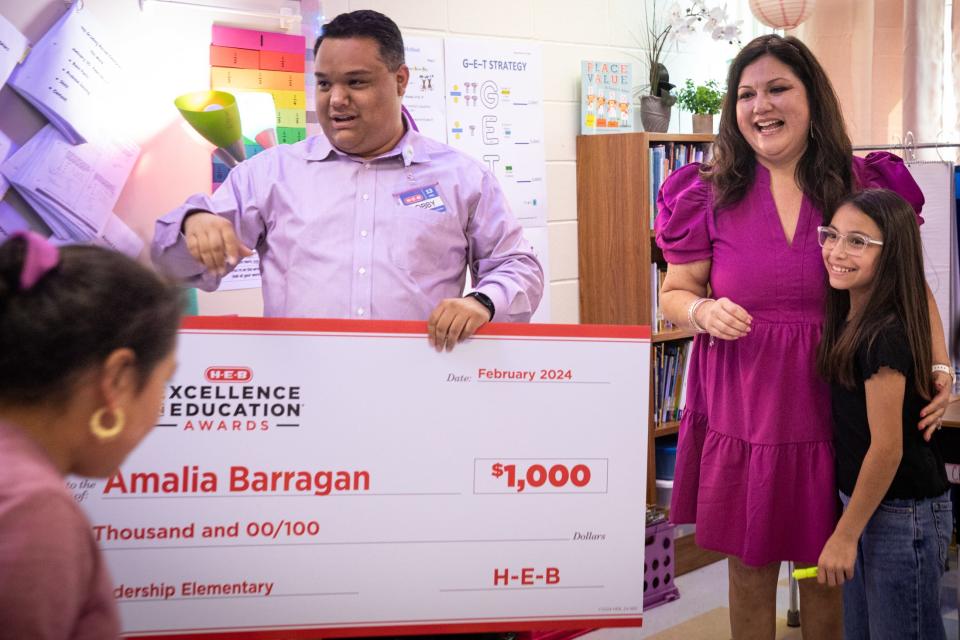 Bobby Rodriguez, with H-E-B, presents fourth grade teacher Amalia "Dolores" Barragan with a check at Zachary Kolda Elementary School on Wednesday, Feb. 7, 2024, in Corpus Christi, Texas.