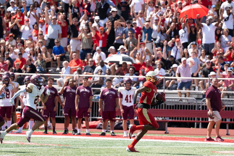 Sept 2, 2023; Oradell, NJ, USA; Iona Prep (NY) at Bergen Catholic (NJ) in a high school football game on Saturday, Sept. 2, 2023. BC #0 Quincy Porter runs for a touchdown after making a catch in the second quarter. Mandatory Credit: Michael Karas-The Record