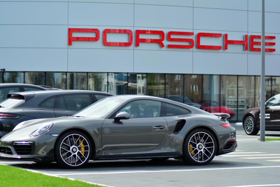 Warsaw,Poland. 15 April. Porsche Centrum Warszawa Okecie. Porsche is a German automobile manufacturer specializing in high-performance cars. Porsche in front of car dealership