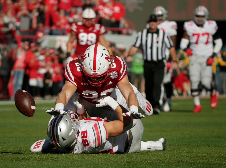 Ohio State Buckeyes tight end Jeremy Ruckert (88) fumbles the football as he is tackled by Nebraska Cornhuskers linebacker Luke Reimer (28) during Saturday's NCAA Division I football game at Memorial Stadium in Lincoln, Neb., on November 6, 2021.