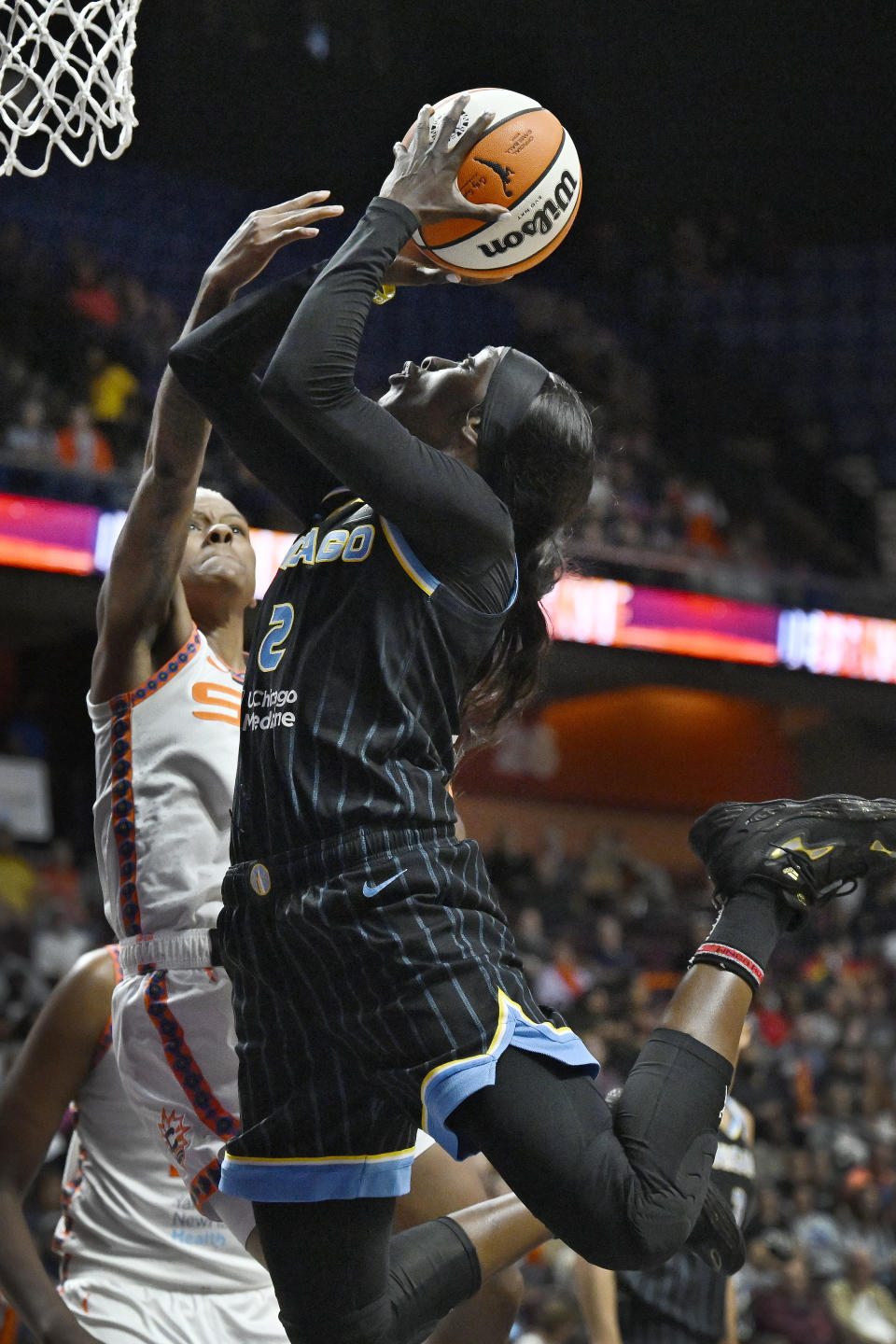 Chicago Sky guard Kahleah Copper, right, is fouled by Connecticut Sun guard Courtney Williams as she shoots during the first half of Game 4 of a WNBA basketball playoff semifinal Tuesday, Sept. 6, 2022, in Uncasville, Conn. (AP Photo/Jessica Hill)