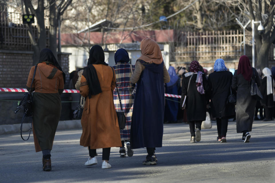 Afghan students walk on a street before they enter their university in Kabul, Afghanistan, Saturday, Feb. 26, 2022. Kabul University, among Afghanistan’s oldest and most revered institutions of higher education, reopened Saturday six months after the Taliban retook the country. There were new restrictions in place, however, including gender segregation and mandatory Islamic dress. (AP Photo/Hussein Malla)