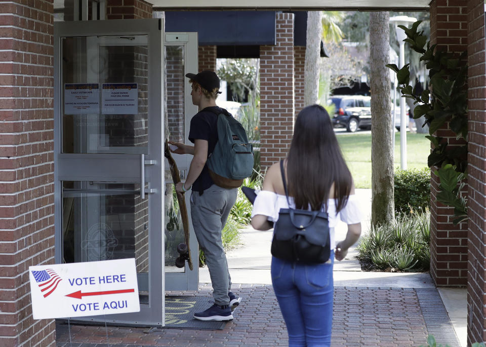 In this Wednesday, Oct. 31, 2018 photo, students enter a polling place to cast their ballots during a Vote for Our Lives event at the University of Central Florida in Orlando, Fla. Nine months after 17 classmates and teachers were gunned down at their Florida school, Parkland students are finally facing the moment they’ve been leading up to with marches, school walkouts and voter-registration events throughout the country: their first Election Day. (AP Photo/John Raoux)