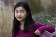 High school student Grace Hu, 16, of Sharon, Mass., stands for a photograph near Sharon High School, Sunday, April 11, 2021, in Sharon. Hu, who plans to to go back to in-person classes in April, helped organize a rally in Boston in early April against anti-Asian hate, but said she's not concerned about facing vitriol when her school reopens fully. The district, located about 27 miles south of Boston, has a sizable Asian student population and has felt generally safe and welcoming to her. (AP Photo/Steven Senne)