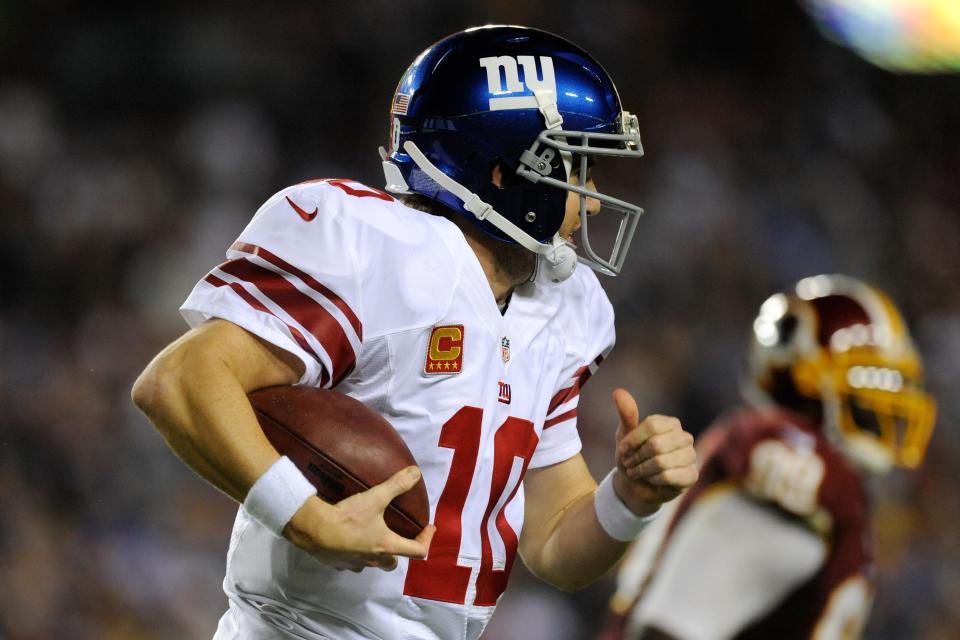 Quarterback Eli Manning #10 of the New York Giants runs five-yards for a first down in the third quarter against the Washington Redskins at FedExField on December 3, 2012 in Landover, Maryland. (Photo by Patrick McDermott/Getty Images)