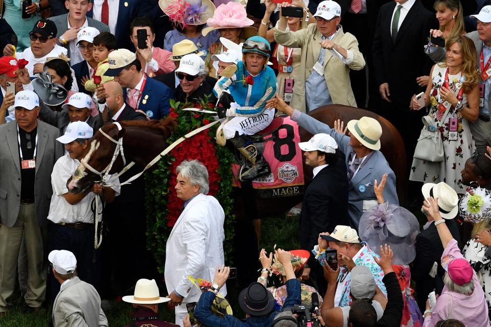 Javier Castellano pitches ones from the garland to the crowd in the Winner’s Circle following his victory aboard Mage in the 147th running of The Kentucky Derby, Saturday, May 6, 2023 in Louisville, Ky.