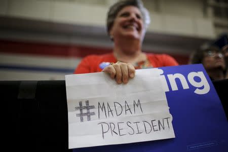 A woman holds a handwritten sign that reads "Madam President" during a "Get Out to Caucus" rally with U.S. Democratic presidential candidate Hillary Clinton in Cedar Rapids, Iowa January 30, 2016. REUTERS/Brian Snyder