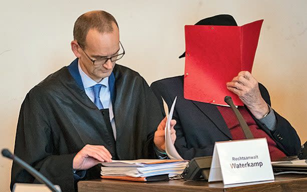 Pictured covering his face at his trial in Hamburg, Dey, a former concentration camp guard, received a suspended sentence this July - POOL/AFP via Getty Images