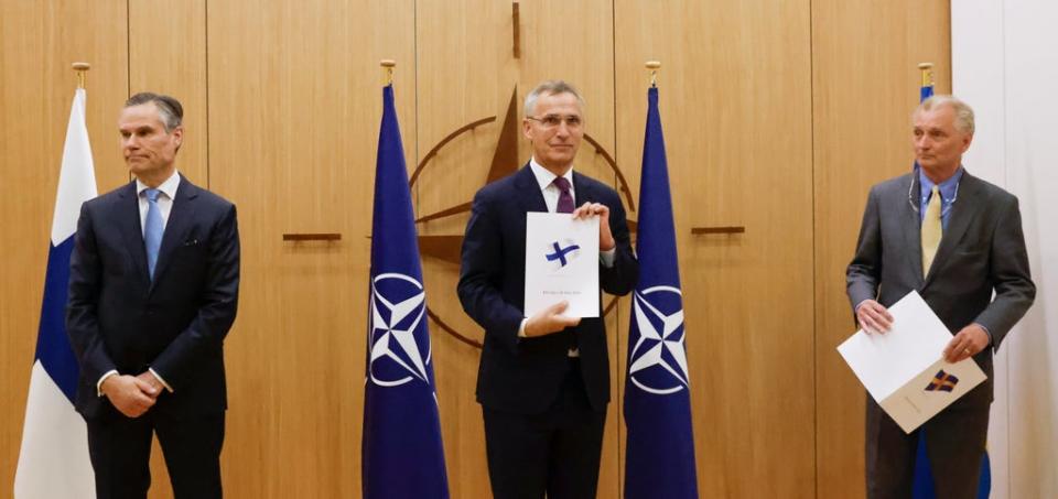 Finland's Ambassador to Nato Klaus Korhonen, NATO Secretary-General Jens Stoltenberg and Sweden's Ambassador to NATO Axel Wernhoff attend a ceremony to mark Sweden's and Finland's application for membership (AP)