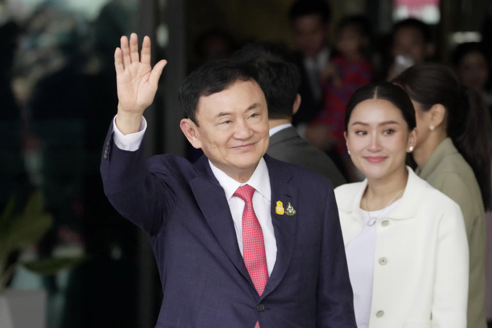 Thailand's former Prime Minister Thaksin Shinawatra, left, with his daughter Paetongtarn Shinawatra arrives at Don Muang airport in Bangkok, Thailand, Tuesday, Aug. 22, 2023. (AP Photo/Sakchai Lalit)