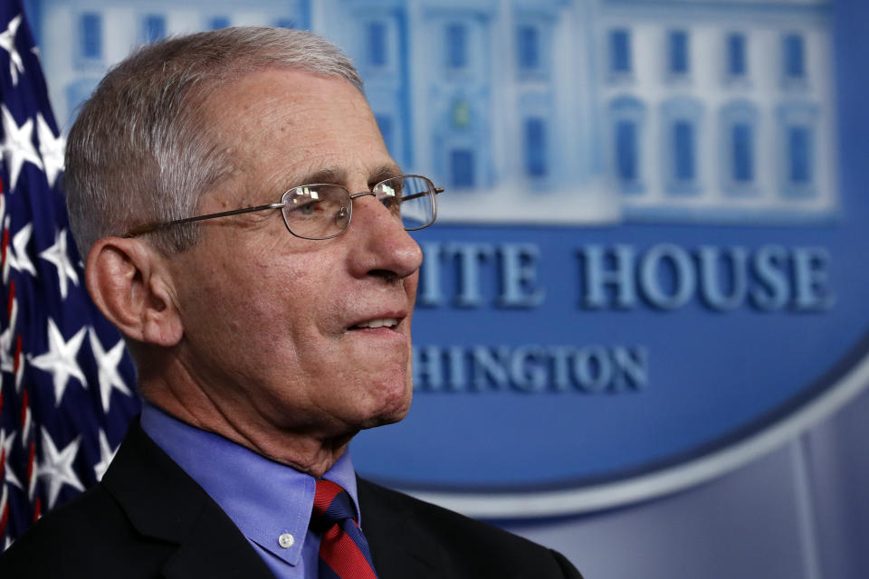 Dr. Anthony Fauci, director of the National Institute of Allergy and Infectious Diseases, listens as President Donald Trump speaks about the coronavirus in the James Brady Briefing Room, Wednesday, March 25, 2020, in Washington. (AP Photo/Alex Brandon)