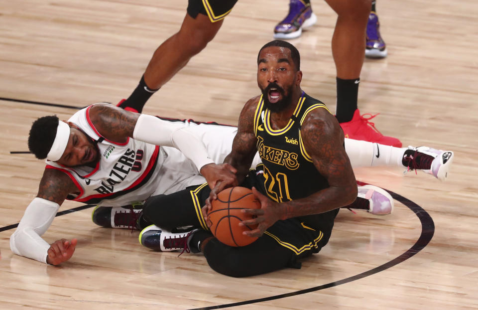 Portland Trail Blazers forward Carmelo Anthony (00) and Los Angeles Lakers guard JR Smith (21) go after the ball in the first half of Game 4 of an NBA basketball first-round playoff series, Monday, Aug. 24, 2020, in Lake Buena Vista, Fla. (Kim Klement/Pool Photo via AP)