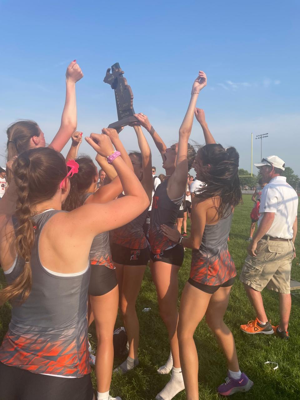 Tecumseh girls track and field team celebrates with the Division 2 regional championship Friday at Milan.