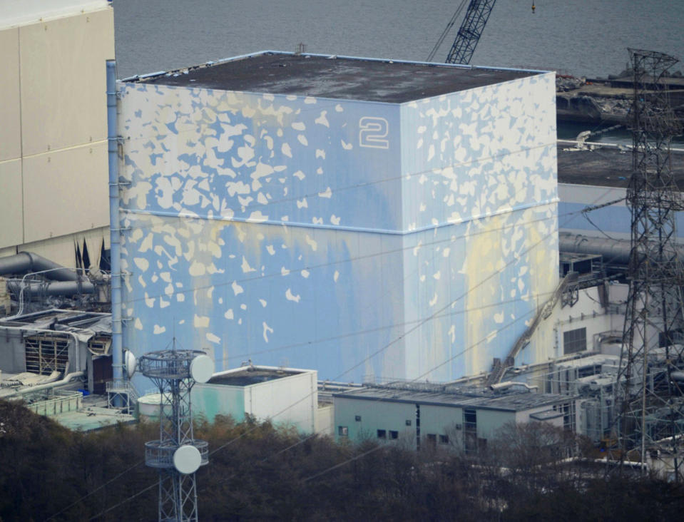 FILE - In this Reactor Unit 2 stands at the tsunami-crippled Fukushima Dai-ichi nuclear power plant in Okuma, Fukushima Prefecture, northeastern Japan. A remote-controlled "cleaning" robot that entered the reactor containment chamber of Unit 2 on Thursday, Feb. 9, 2017, was withdrawn before completing its mission due to glitches most likely caused by high radiation. (Kyodo News via AP, File)