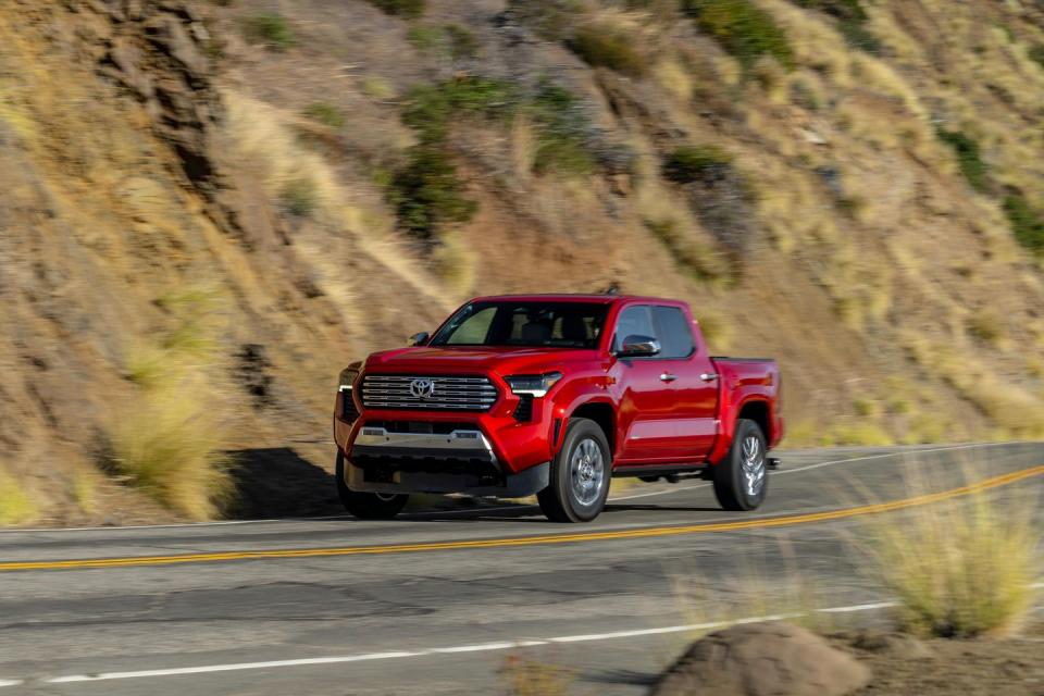 2024 toyota tacoma painted red on mountain road