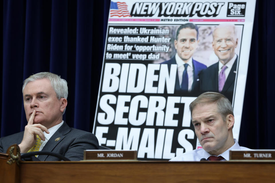 Republican Reps. James Comer, left, and Jim Jordan at a House Oversight Committee hearing in February, with a poster of a New York Post front-page story about Hunter Biden's emails on display. 