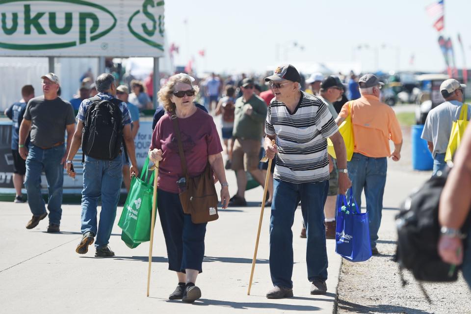 Visitors look around the Farm Progress Show on Tuesday in Boone.