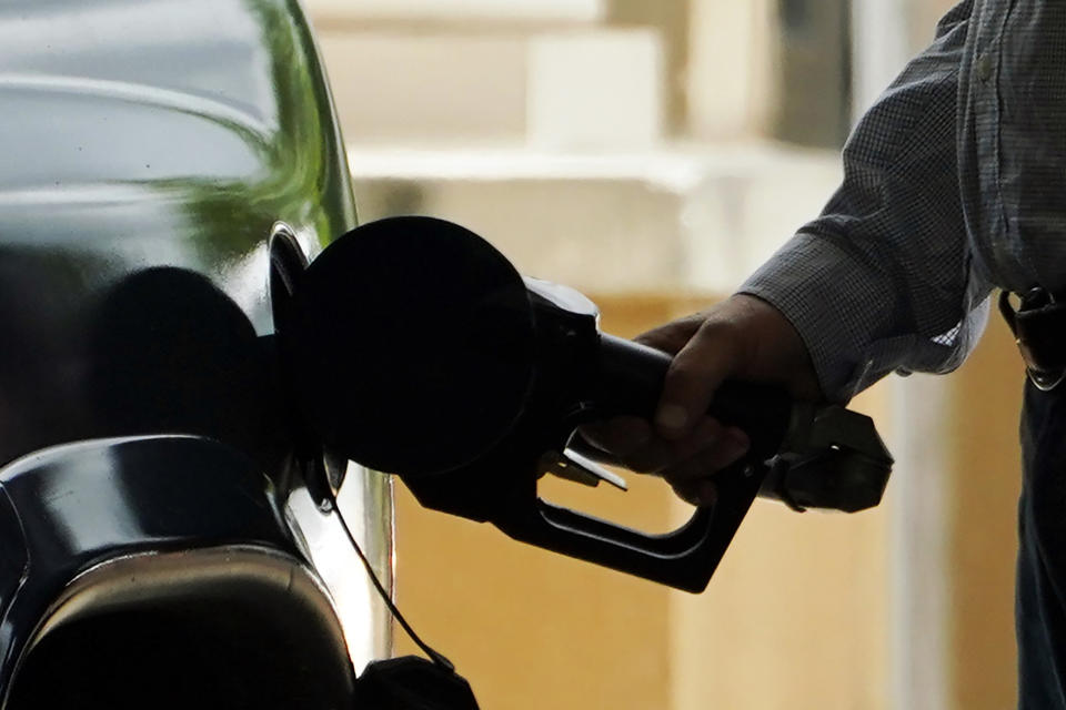 FILE- A customer pumps gas into his vehicle at this Madison, Miss., Sam's Club, on May 24, 2022. On Friday, July 15, 2022, The Associated Press reported on stories circulating online incorrectly claiming that U.S. gasoline prices are not among the lowest in the world. While the U.S. is not one of the nations with the highest fuel prices in the world in 2022, it is also not among those with the lowest prices. More than 60 countries report lower gas prices than those in the U.S., according to the website GlobalPetrolPrices.com. (AP Photo/Rogelio V. Solis, File)